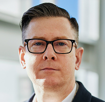 Geschäftsführer Alexander Hughes in einem CEO-Porträt des Kryptowährungshandelunternehmens